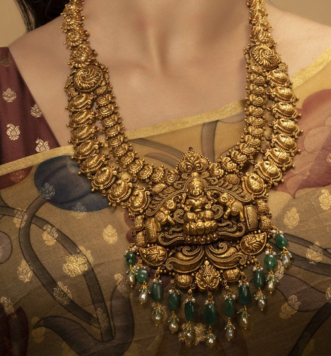 Heavily crafted lakshmi devi themed gold necklace