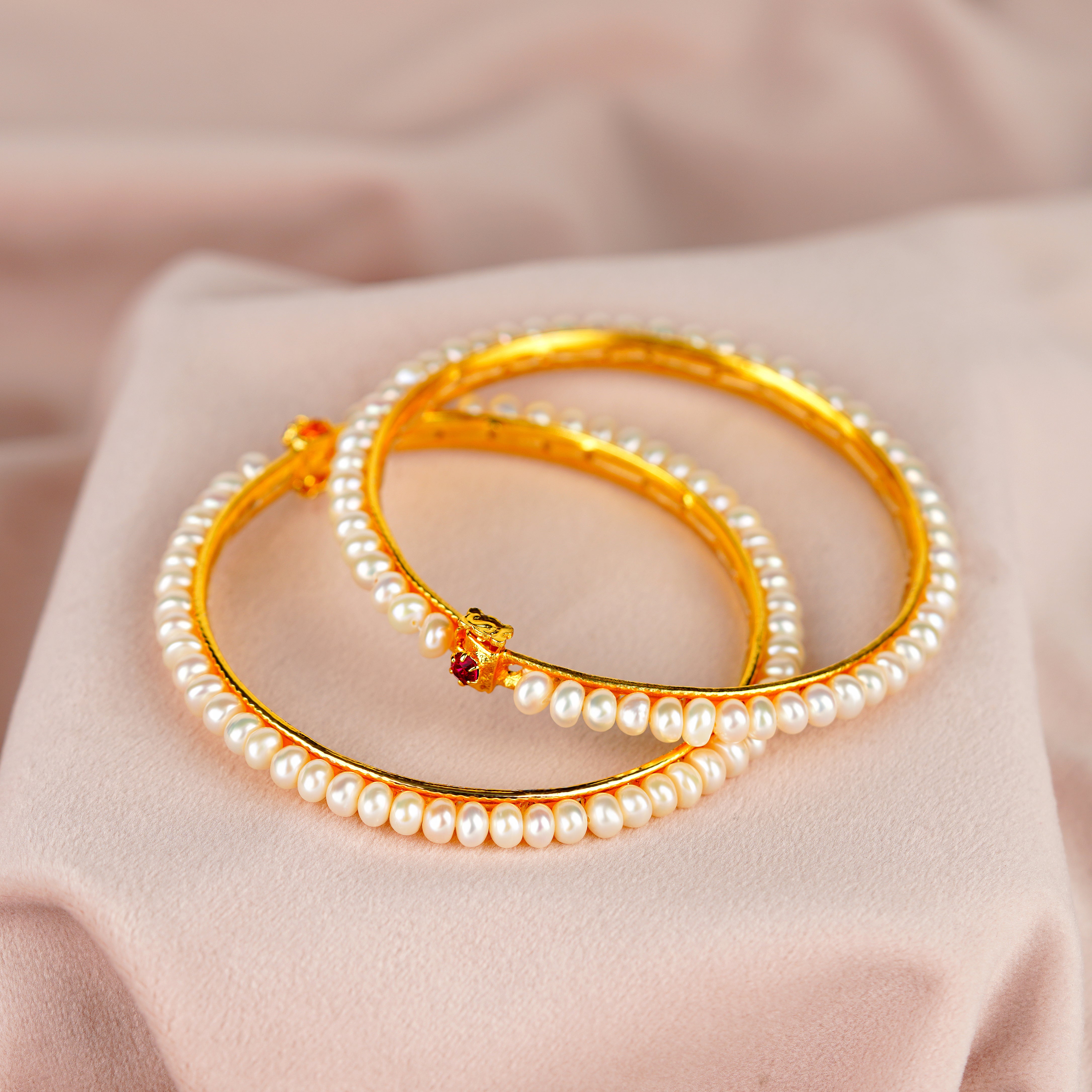 Elegant White Pearl Bangles with Sparkling Red Stones