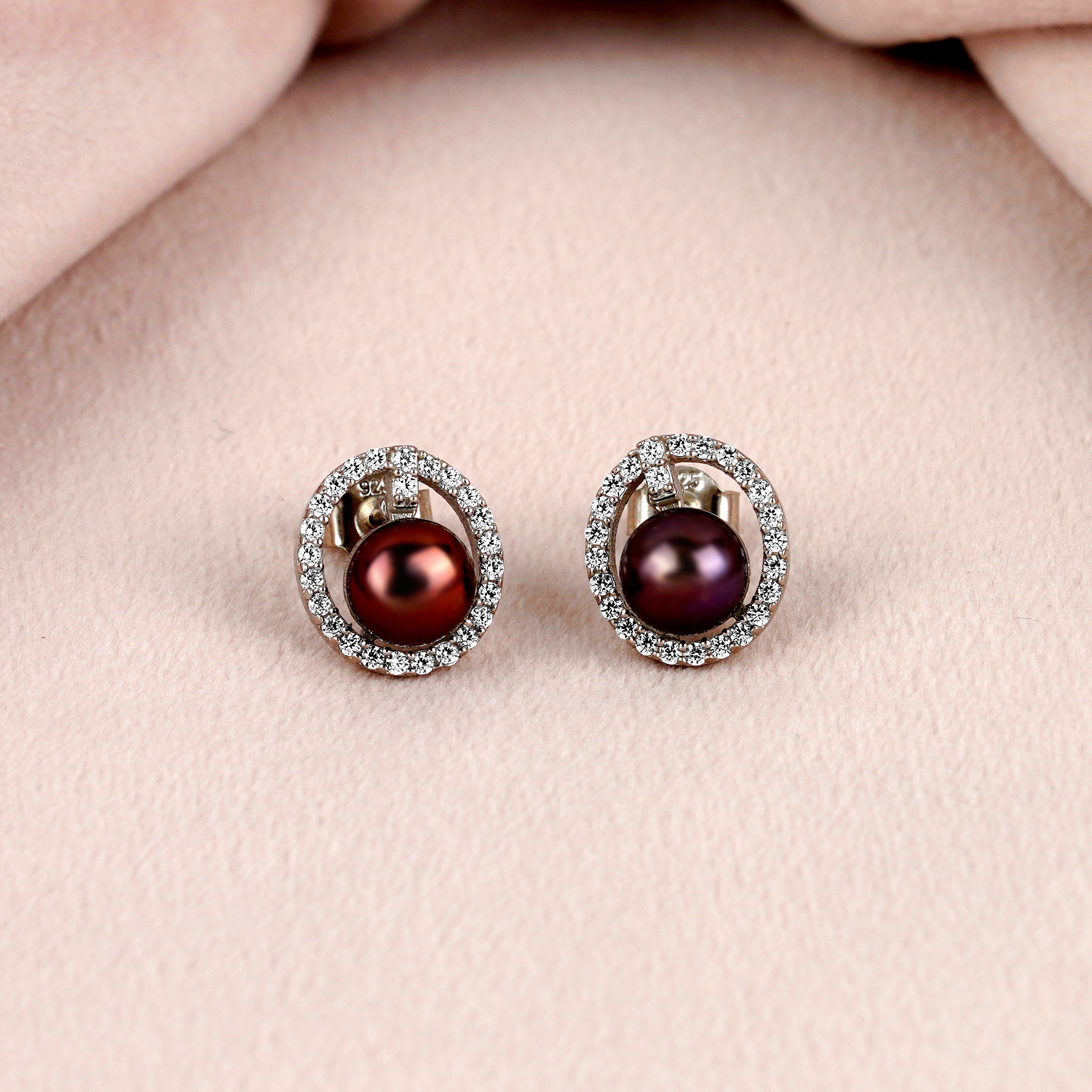 Captivating stud earrings set with a fresh water pearl and CZ stones