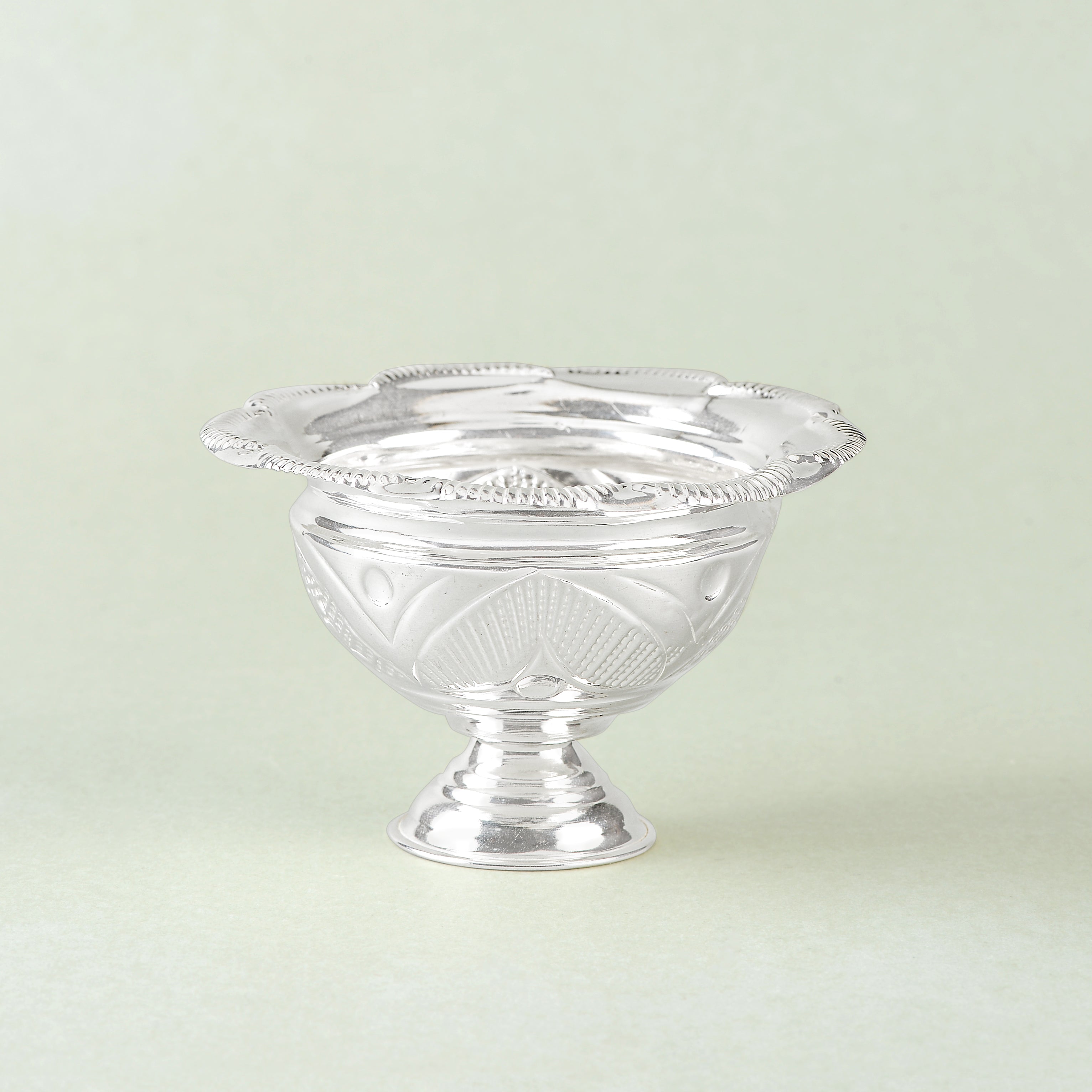 Silver bowls with flower petal motifs.