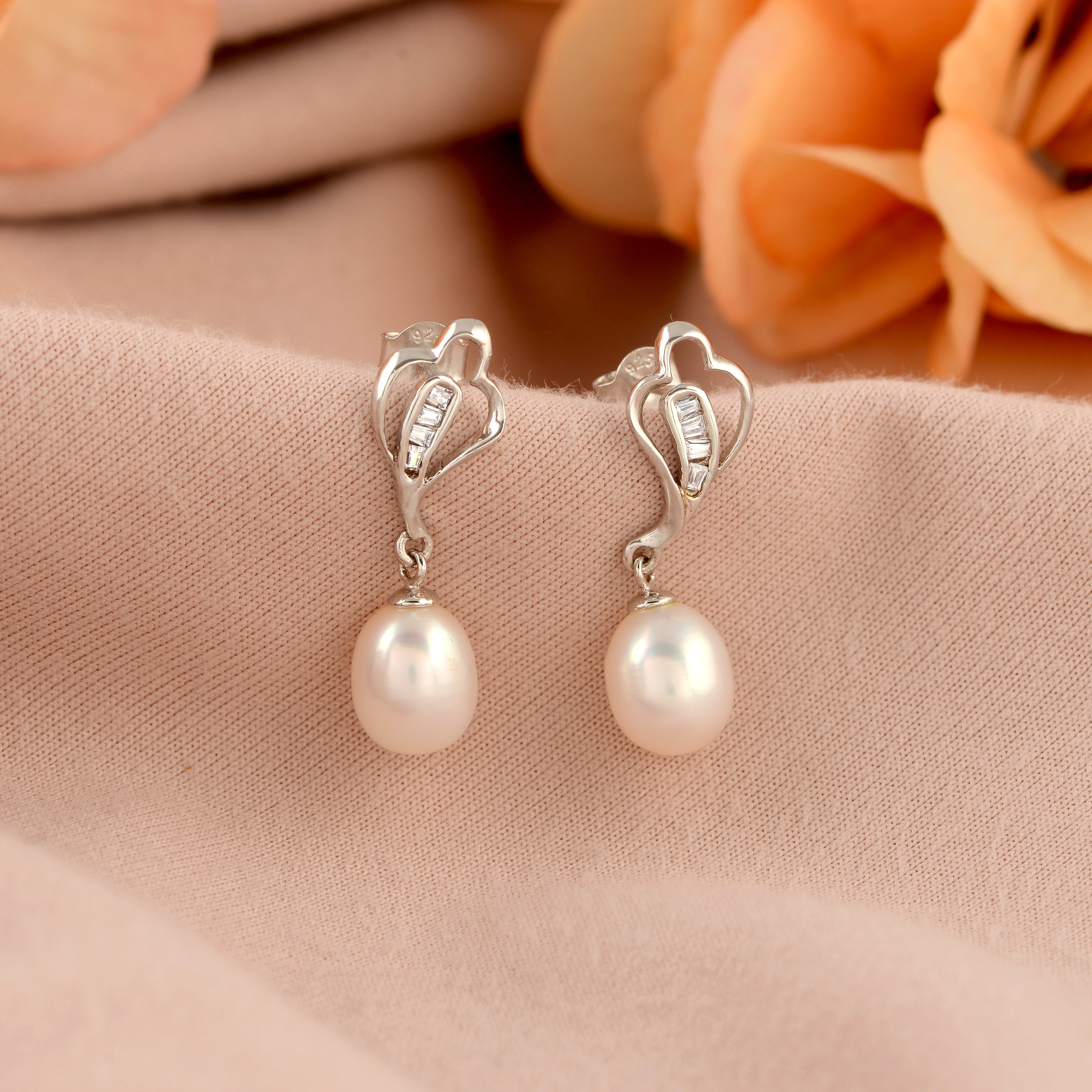 Silver paan leaf earrings with pearls.