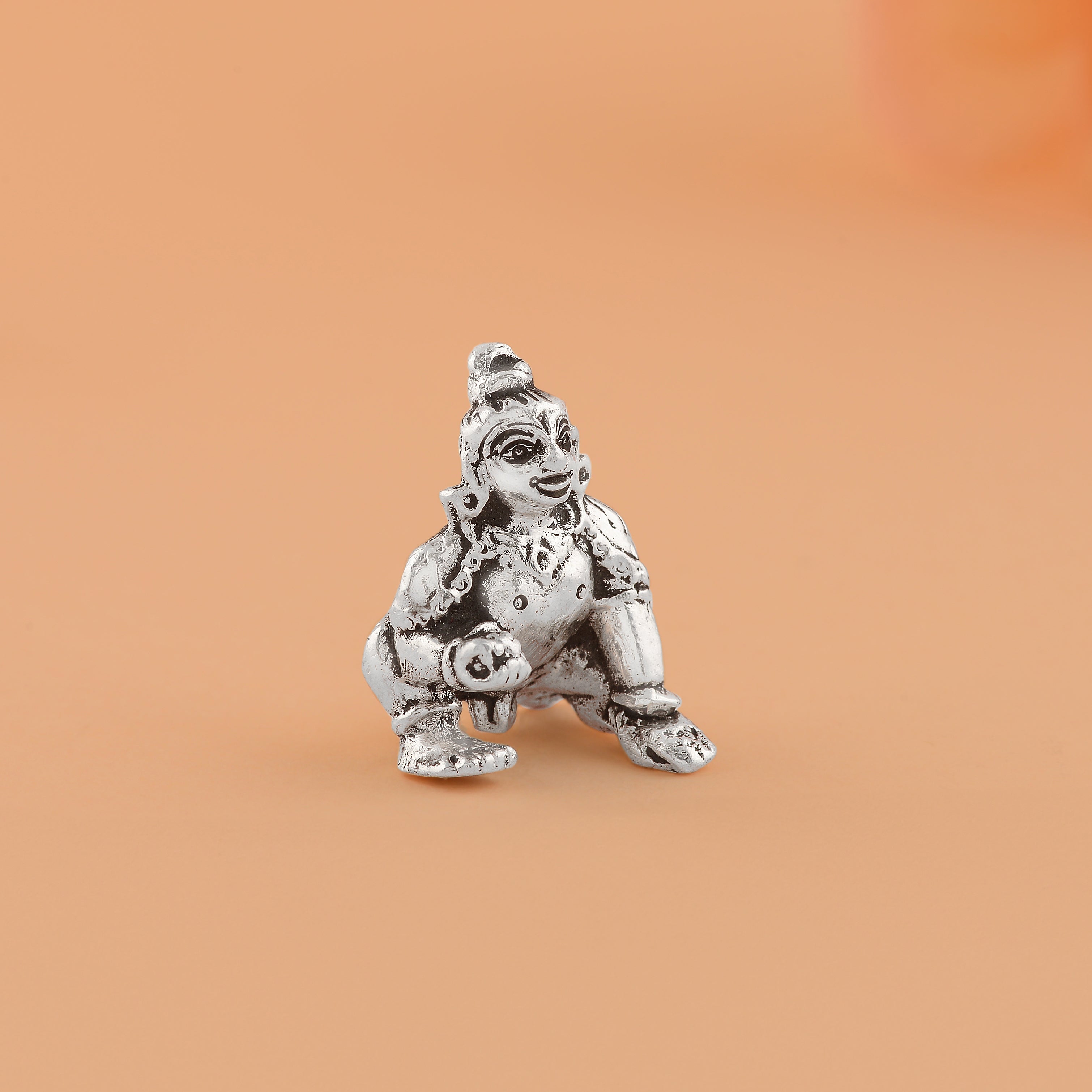 Silver lord Gopal Krishna embodies innocent delight.